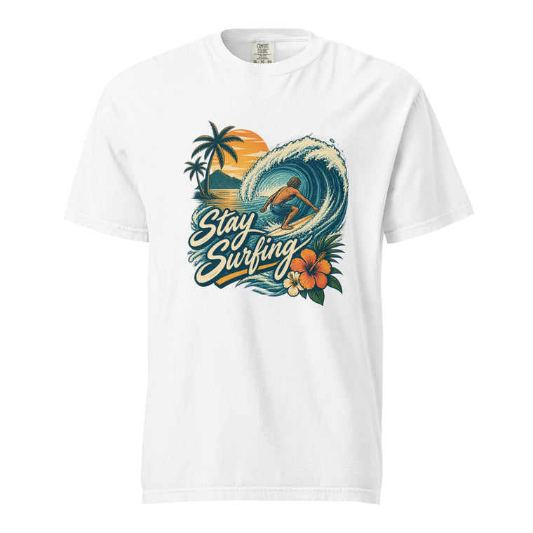 White T-shirt with a surfer riding a curling ocean wave, palm trees, sunset, tropical flowers, and Stay Surfing lettering.
