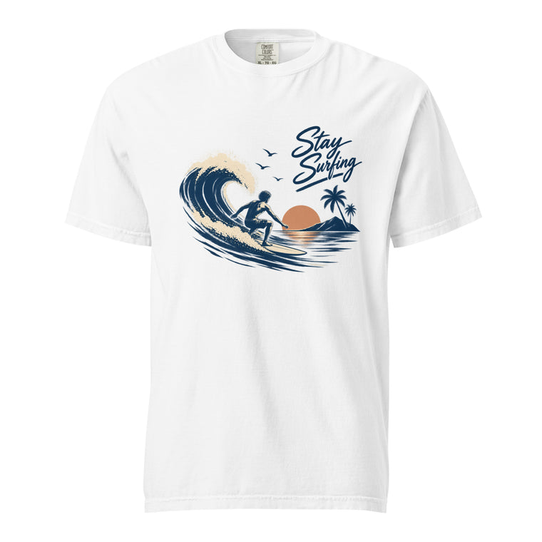 Front view of a White T-shirt featuring a surfer riding a wave with palm trees, a sun, and “Stay Surfing” text.