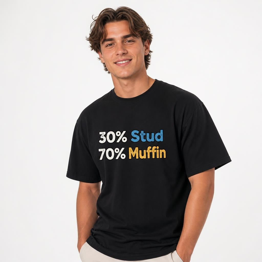 Model wearing a black T-shirt with bold distressed typography reading “30% Stud” and “70% Muffin” in blue, yellow, and white.