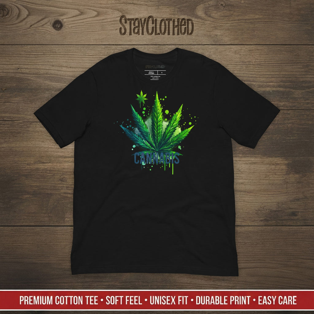 Black t-shirt with cannabis leaf design on a wooden surface, featuring the brand 'StayClothed'.