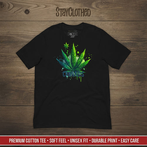 Black t-shirt with cannabis leaf design on a wooden surface, featuring the brand 'StayClothed'.