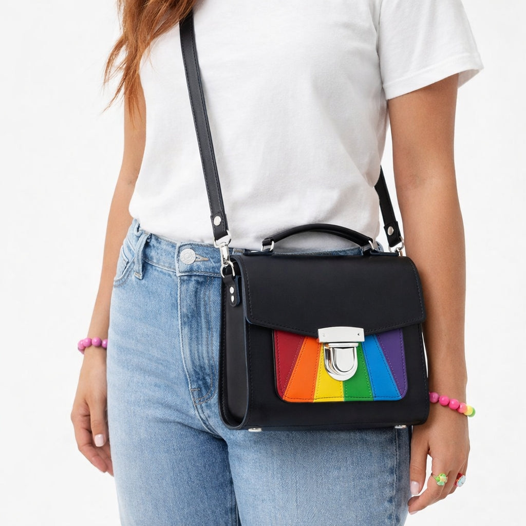 Person wearing a black bag with a rainbow panel on a white background