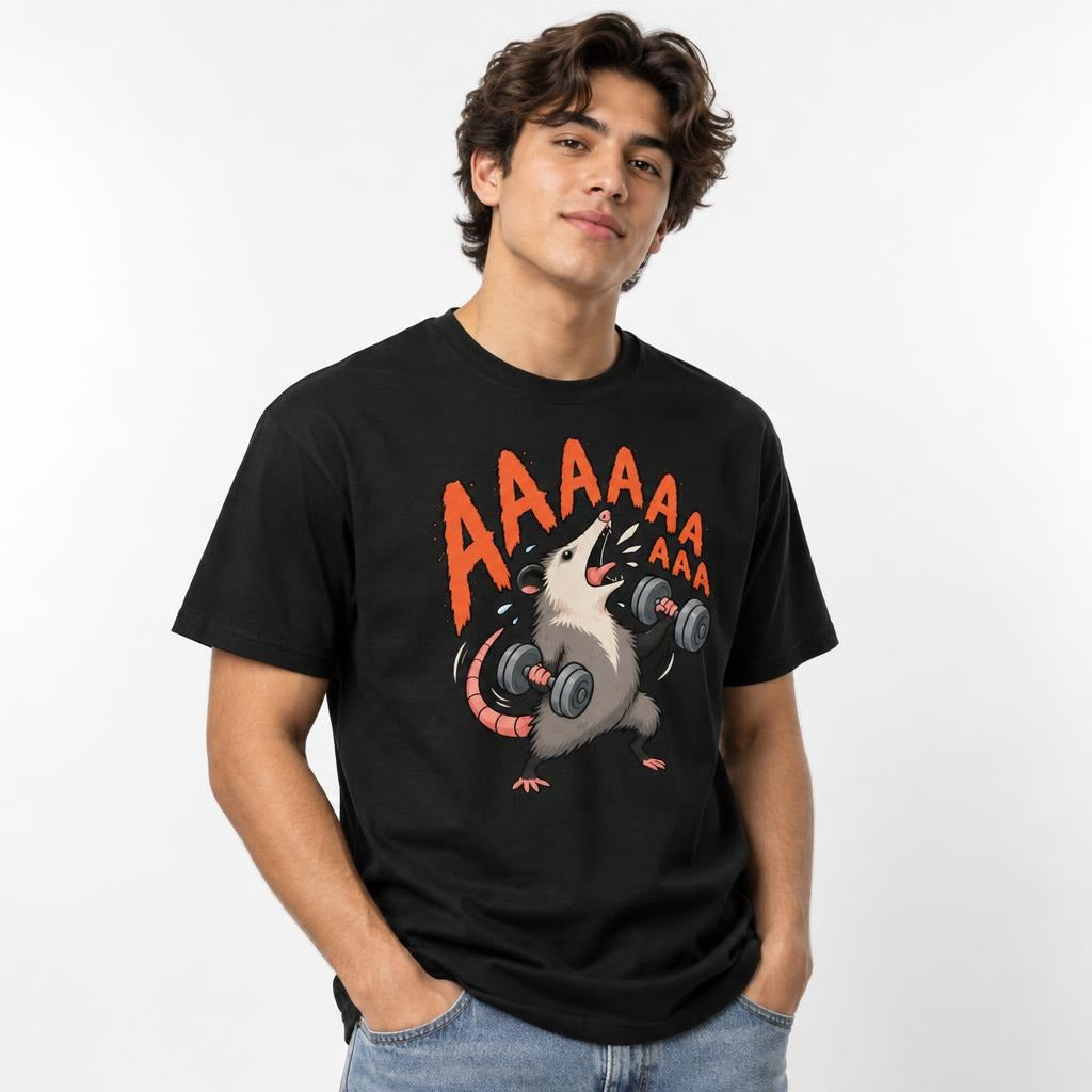 Model wearing a black T-shirt with a hand-drawn rat lifting two dumbbells beneath bold orange “AAAAA” lettering.