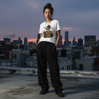 East Asian woman in urban streetwear wearing a white Today Im Feeling Ambitchous skeleton girl t-shirt
