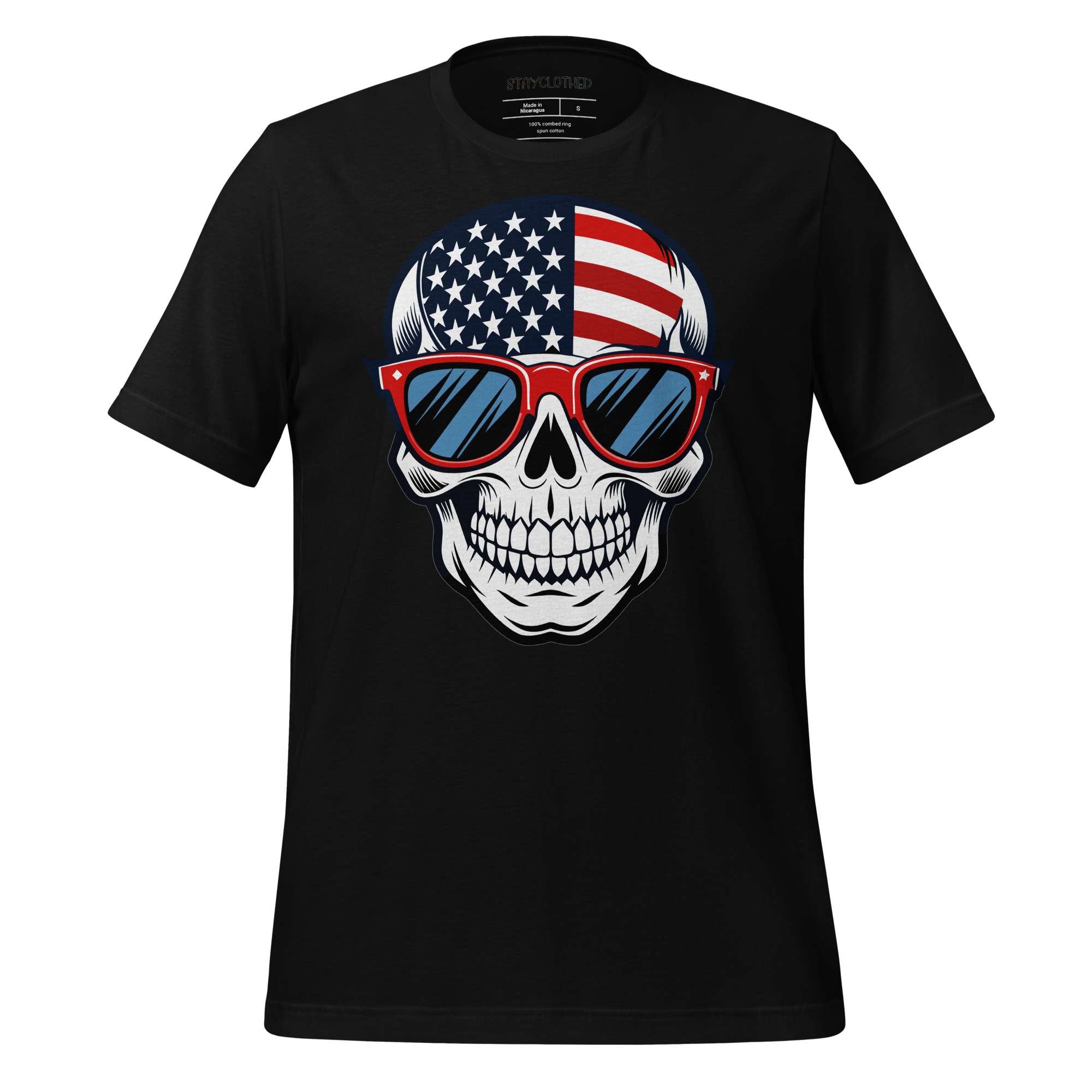 Black t-shirt with a skull design wearing American flag sunglasses on a wooden surface, branded 'StayClothed'.