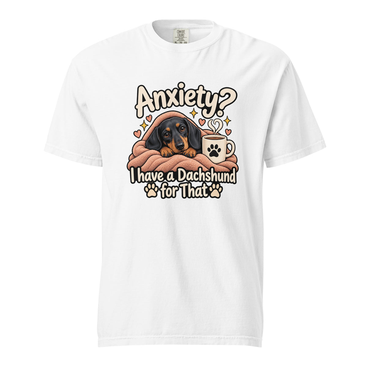Front view of a white T-shirt featuring a cosy black-and-tan dachshund wrapped in a blanket beside a coffee mug, with “Anxiety?” text.