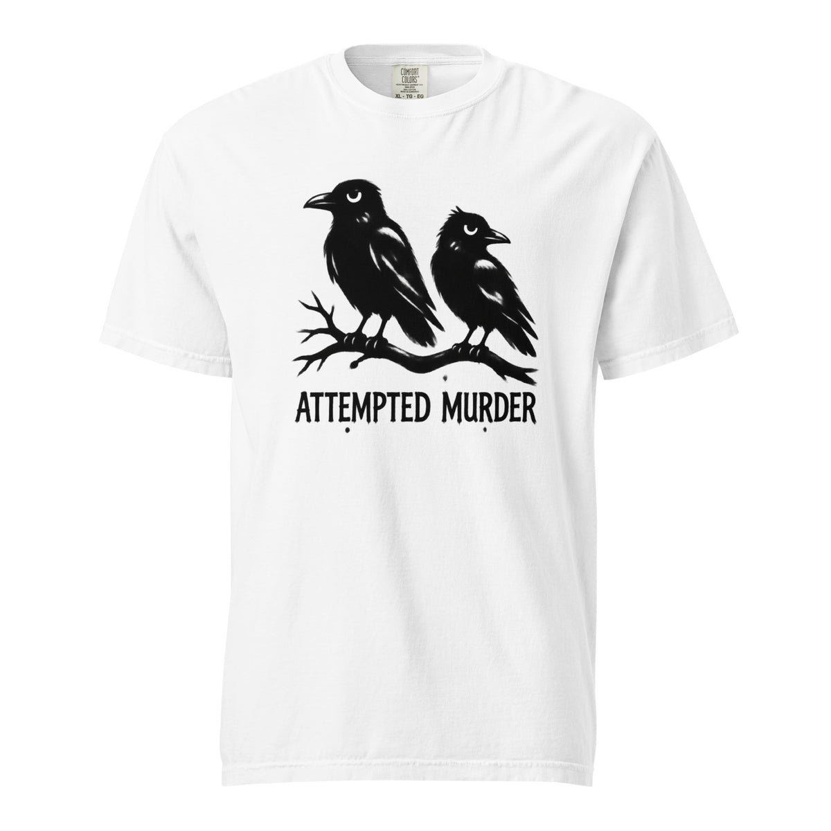 Front view of a white T-shirt featuring two black crows perched on a branch above the words “ATTEMPTED MURDER.”