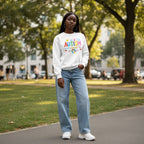Black woman wearing a white autism awareness sweatshirt.