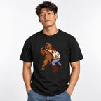 Front view of a model wearing a black T-shirt with a vintage illustration of a man wrestling a roaring brown bear.