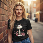 Woman wearing a black t-shirt with a cat design, standing against a brick wall.