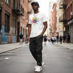Black man wearing a white autism awareness rainbow sunflower t-shirt.