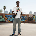 Black man wearing a white autism acceptance infinity symbol t-shirt.