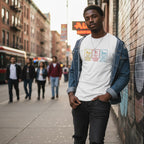 Black man wearing a white autism awareness T-shirt in a streetwear style.