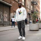 Black man wearing a white be kind autism awareness sweatshirt.