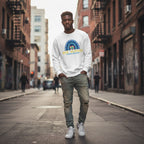 Black man wearing a white be kind autism awareness sweatshirt.