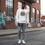 Black man wearing a white Be Kind autism awareness puzzle sweatshirt.