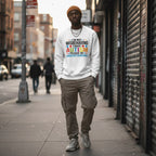 Black man wearing a white autism awareness sweatshirt.