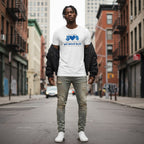 Black man wearing a white In April We Wear Blue autism awareness t-shirt.