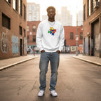 Black man wearing a white autism awareness sweatshirt featuring a puzzle heart logo.