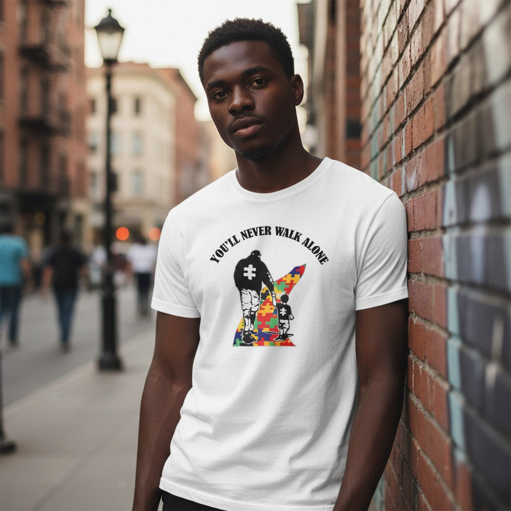 Black man wearing a white autism awareness t-shirt.
