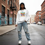 Black woman wearing a white autism mama sweatshirt.