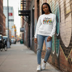 Black woman wearing a white autism mama sweatshirt.