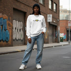 Black woman wearing a white autism heartbeat puzzle sweatshirt.