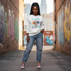 Black woman wearing a white It's Okay To Be Different autism awareness elephant sweatshirt.