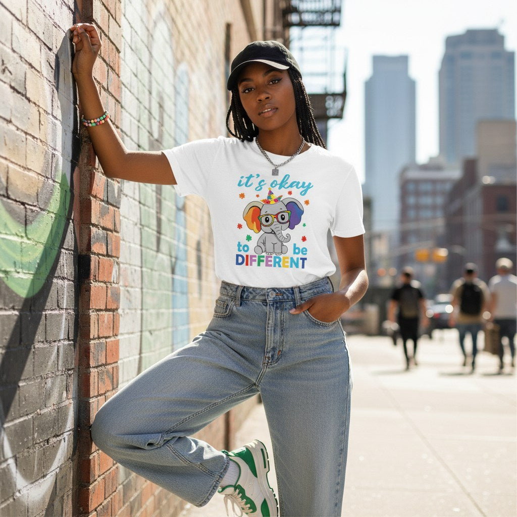 Black woman wearing a white its okay to be different autism awareness elephant t-shirt.