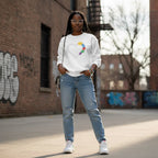 Black woman wearing a white puzzle heart sweatshirt.