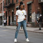 Black woman wearing a white autism awareness puzzle heart t-shirt in a streetwear style.