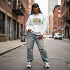 Black woman wearing a white autism awareness sweatshirt in a streetwear style.