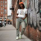 Black woman wearing a white autism awareness t-shirt.