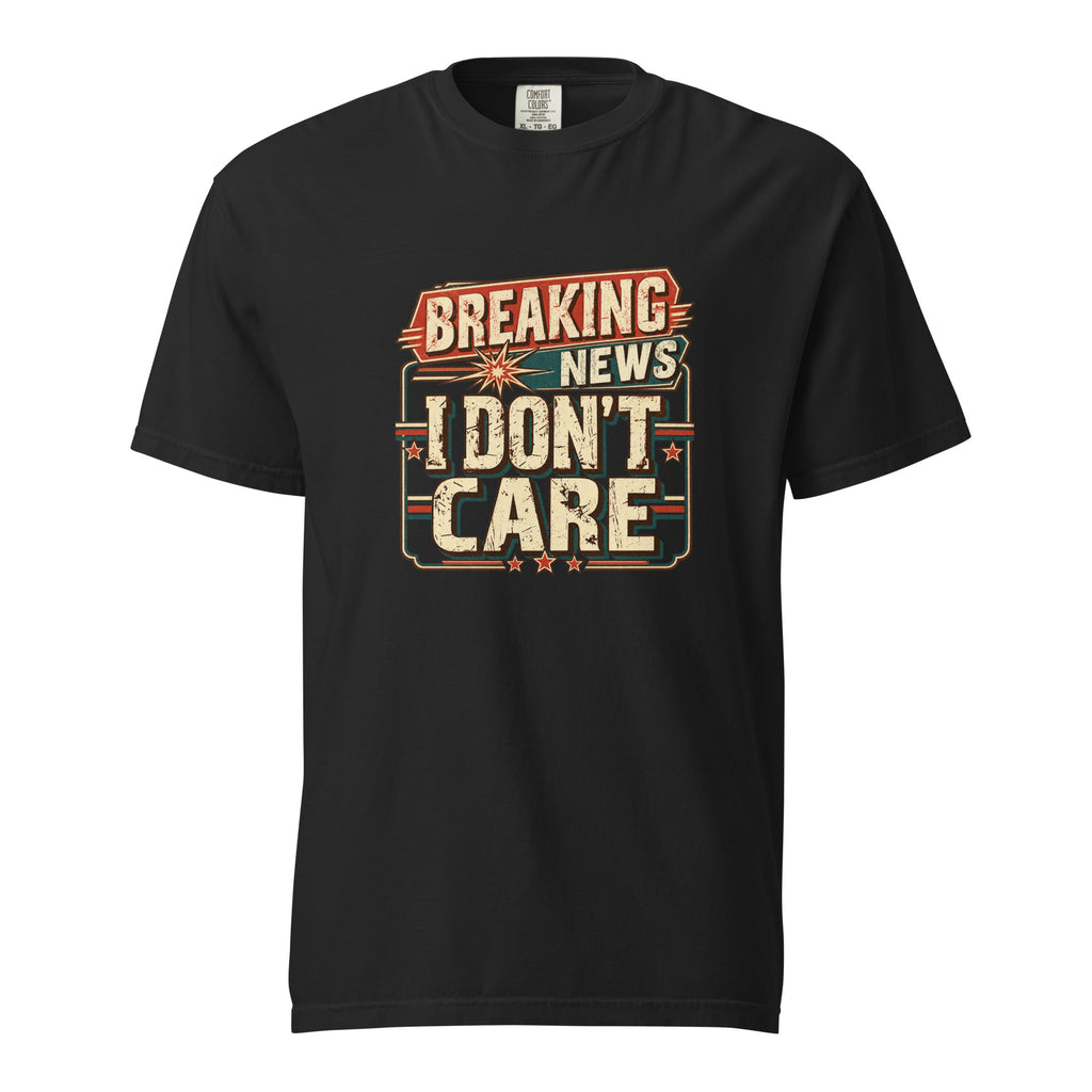 Black T-shirt with a distressed retro graphic reading “BREAKING NEWS I DON’T CARE” in bold cream, red, and teal lettering.