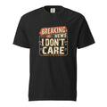 Black T-shirt with a distressed retro graphic reading “BREAKING NEWS I DON’T CARE” in bold cream, red, and teal lettering.