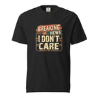 Black T-shirt with a distressed retro graphic reading “BREAKING NEWS I DON’T CARE” in bold cream, red, and teal lettering.