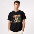 Breaking News I Dont Care t shirt in Black worn by a studio model in an upper-body front relaxed pose on a clean white background