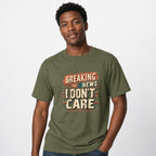 Breaking News I Dont Care t shirt in Hemp worn by a studio model in an upper-body walking pose on a clean white background