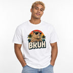 Front view of a person wearing a White T-shirt with a retro capybara in black sunglasses, palm trees, sunset stripes, and “BRUH” text.