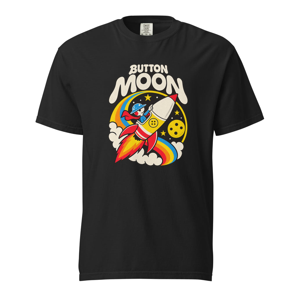 Black T-shirt with cream “BUTTON MOON” lettering above a cartoon astronaut riding a rocket, with a moon, stars and rainbow arcs.
