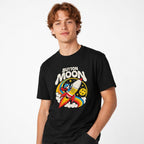 Model wearing a Black T-Shirt with “BUTTON MOON” lettering above a cartoon astronaut riding a rocket beside a cratered moon.