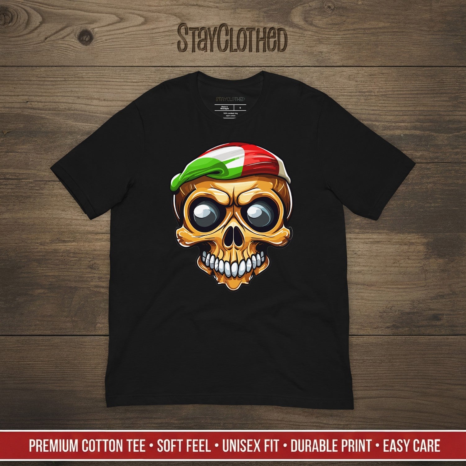 Black t-shirt with a colorful skull design on a wooden surface, featuring the brand 'StayClothed'.