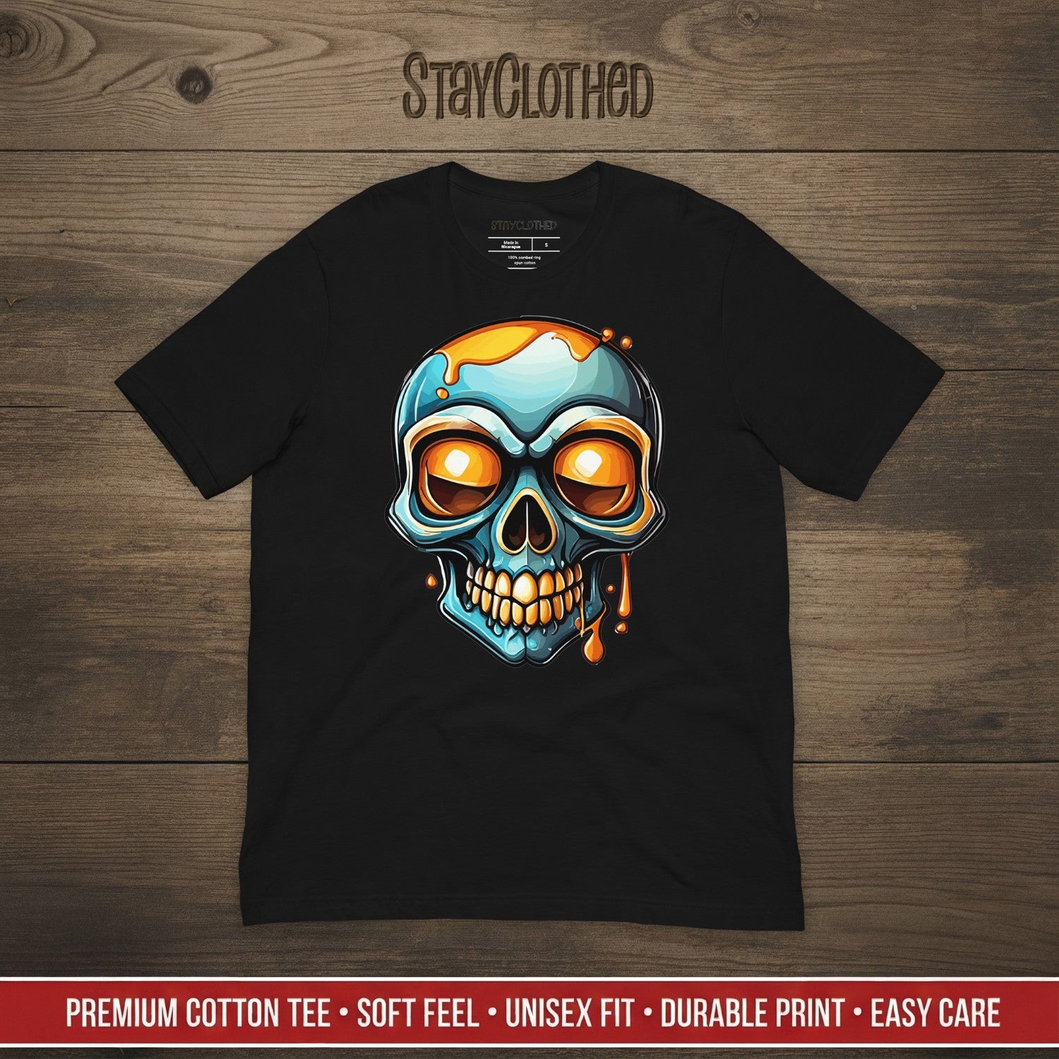 Black t-shirt with a colorful skull design on a wooden surface, featuring the brand 'StayClothed'.