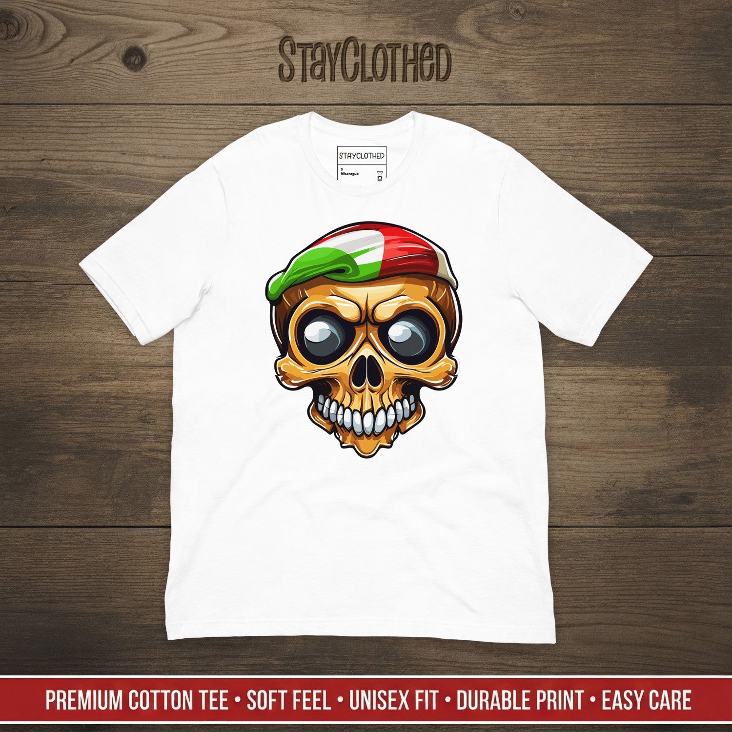 White t-shirt with a colorful skull graphic on a wooden surface, featuring the brand 'StayClothed'.