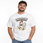 Model wearing a White T-shirt with a cartoon chicken in motion and bold “CHICKEN GAME,” “DON’T LOOK AT THE CHICKEN.” and “GAME OVER” text.