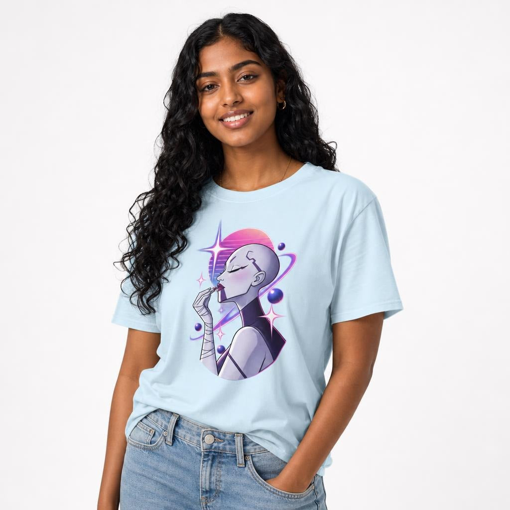 Front view of a model wearing a chambray T-shirt with a futuristic woman applying lipstick among pink and purple planets and stars.