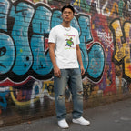 East Asian man wearing a white "Be Happy In Your Own Shell" rainbow turtle t-shirt.