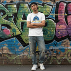 East Asian man wearing a white Be Kind autism awareness t-shirt.