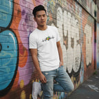 East Asian man wearing a white autism awareness heartbeat puzzle T-shirt.
