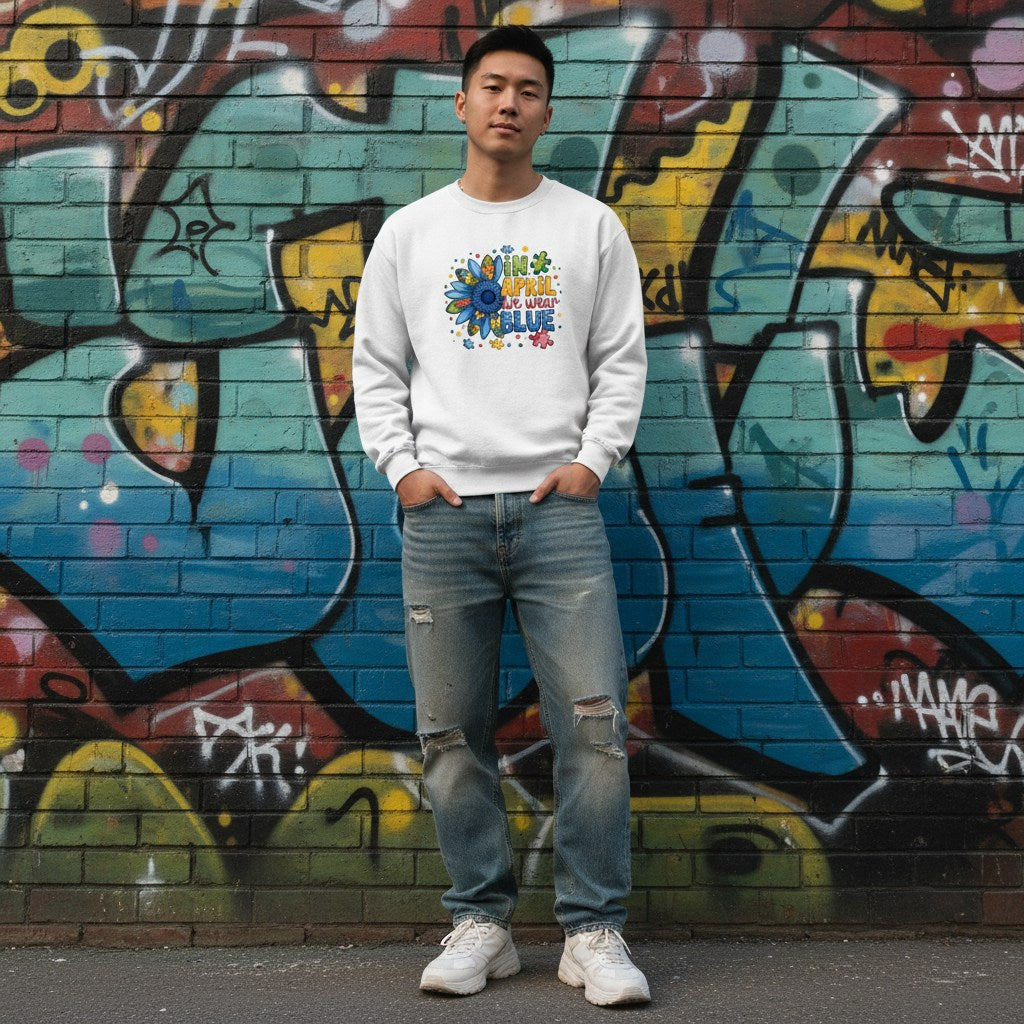 East Asian man wearing a white In April We Wear Blue autism sunflower sweatshirt.